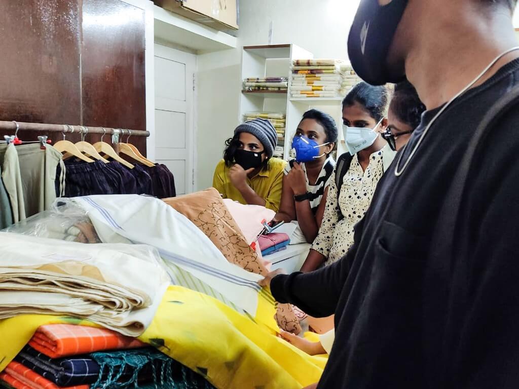 Industrial Visit To Gramins Lifestyle: Students engrossed in the various hand woven fabrics that are available at the store